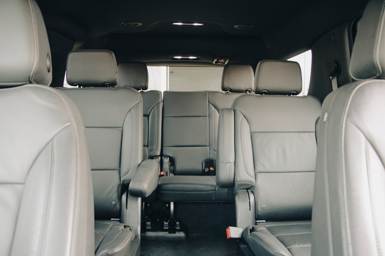 Explore the luxurious empty leather seats of a modern car interior, showcasing spacious design and comfort.
